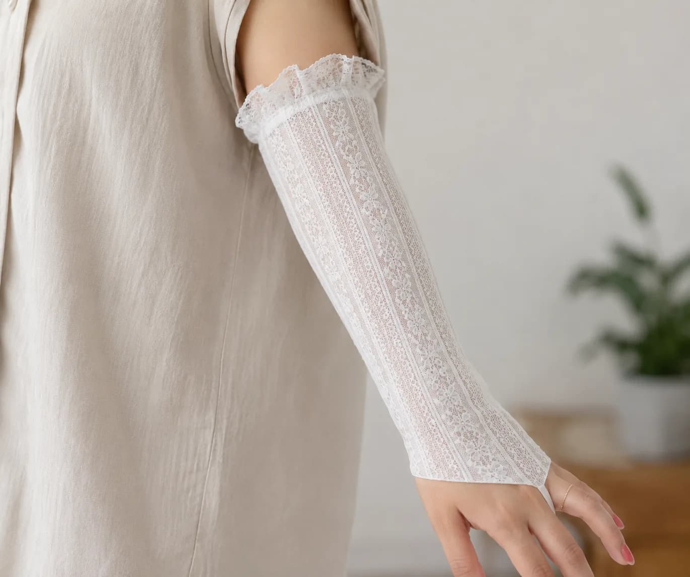 Custom white lace PICC line cover with ruffle detailing on a forearm