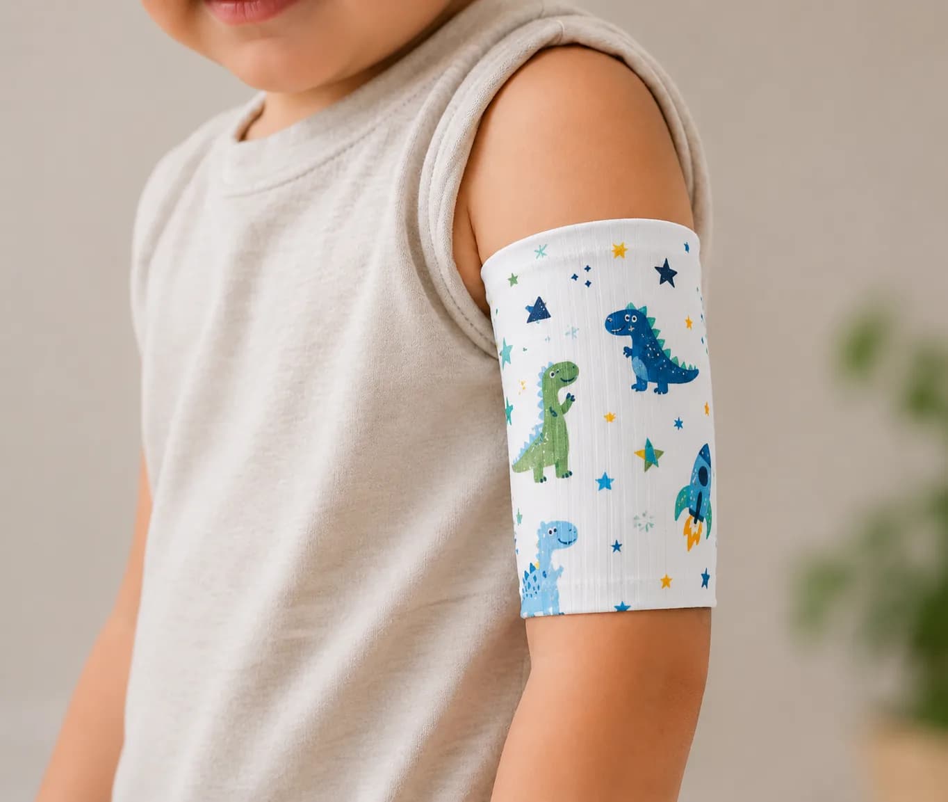 Child wearing a white PICC line cover with a playful dinosaur pattern