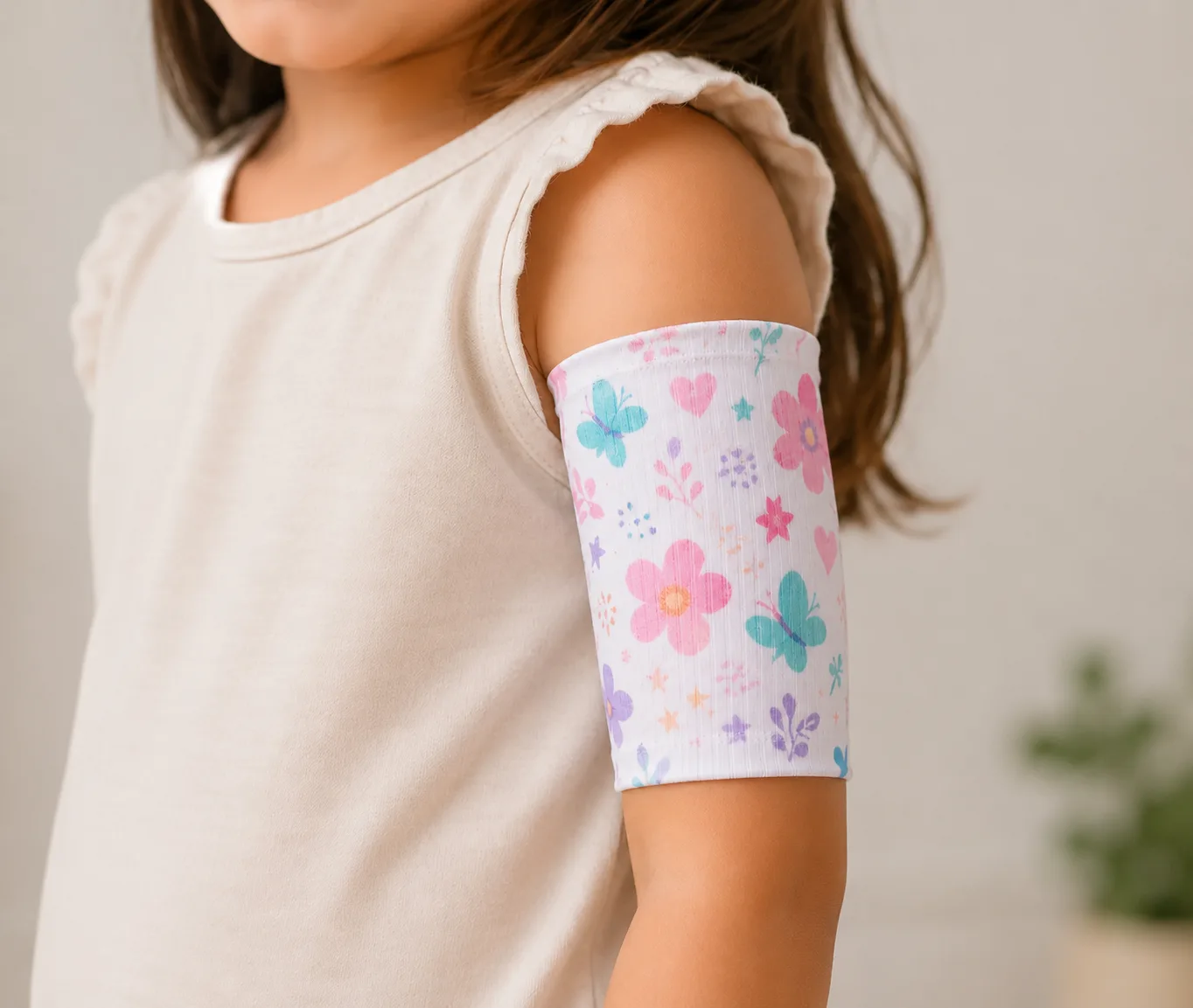 Child wearing a white PICC line cover with a pastel butterfly pattern