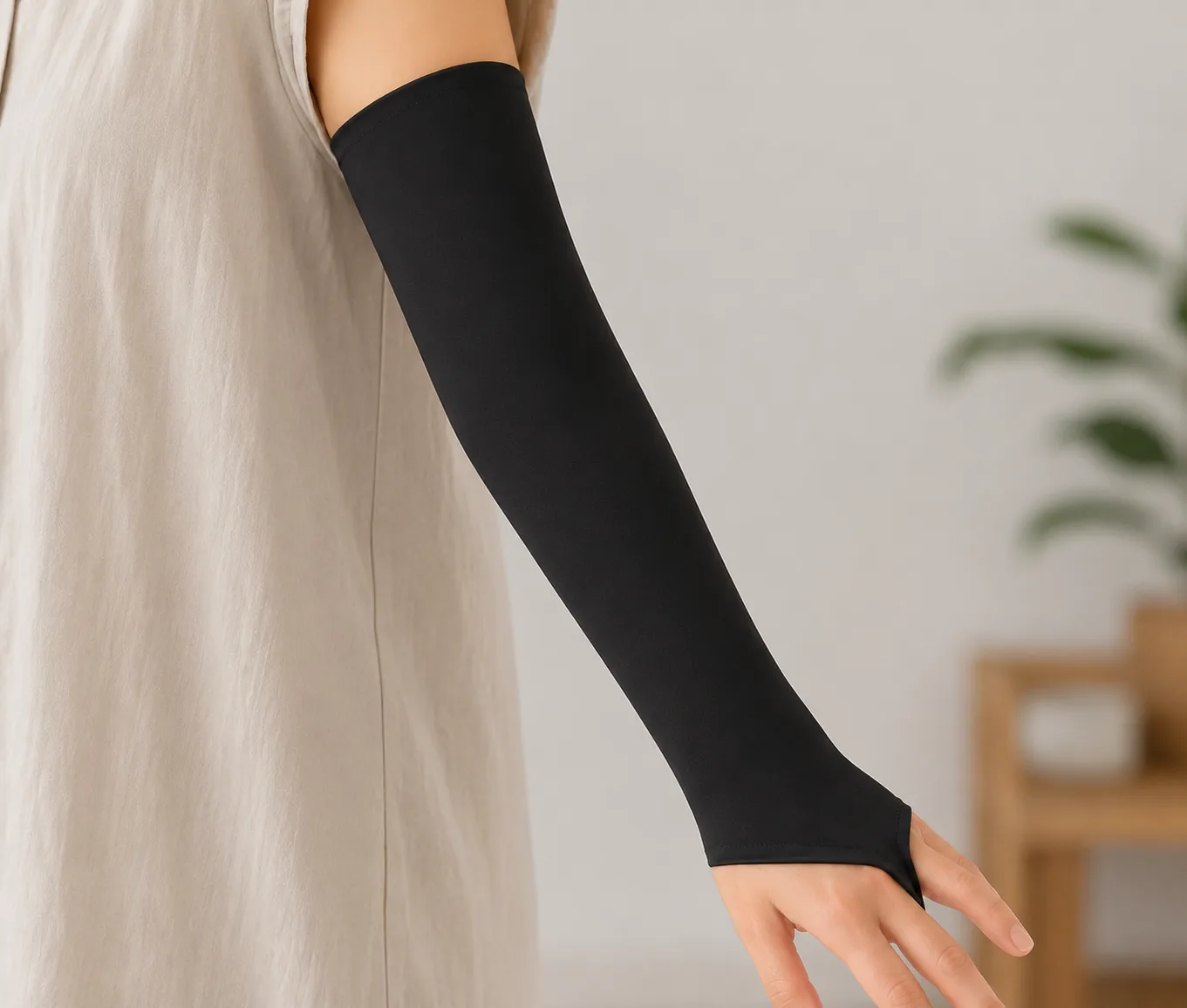 Full-length black PICC sleeve with thumbhole, worn from upper arm to hand